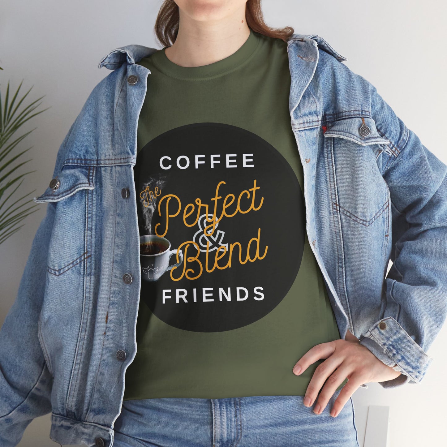 Coffee Lovers Cotton T-shirt, Person wearing a green t-shirt with a coffee-themed design, standing indoors.