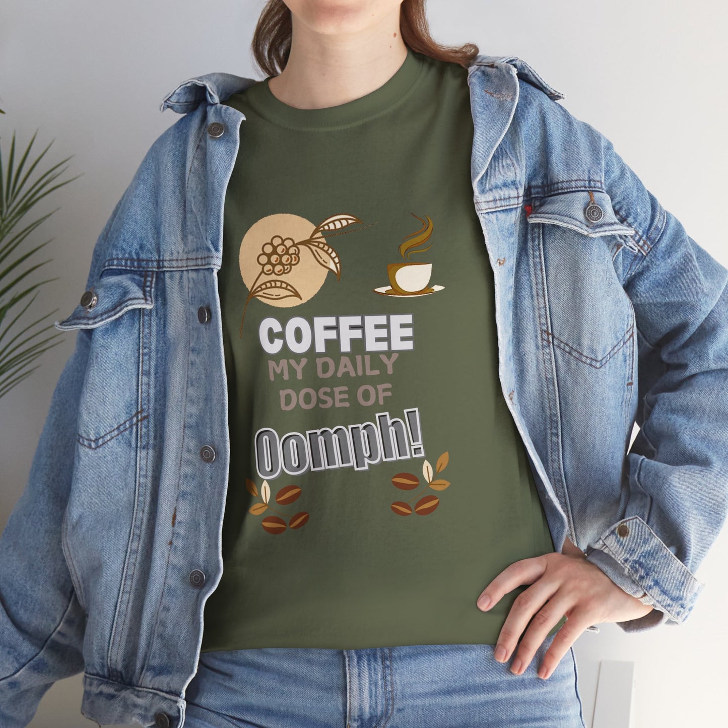 Person wearing a green t-shirt with a coffee-themed design and denim jacket.