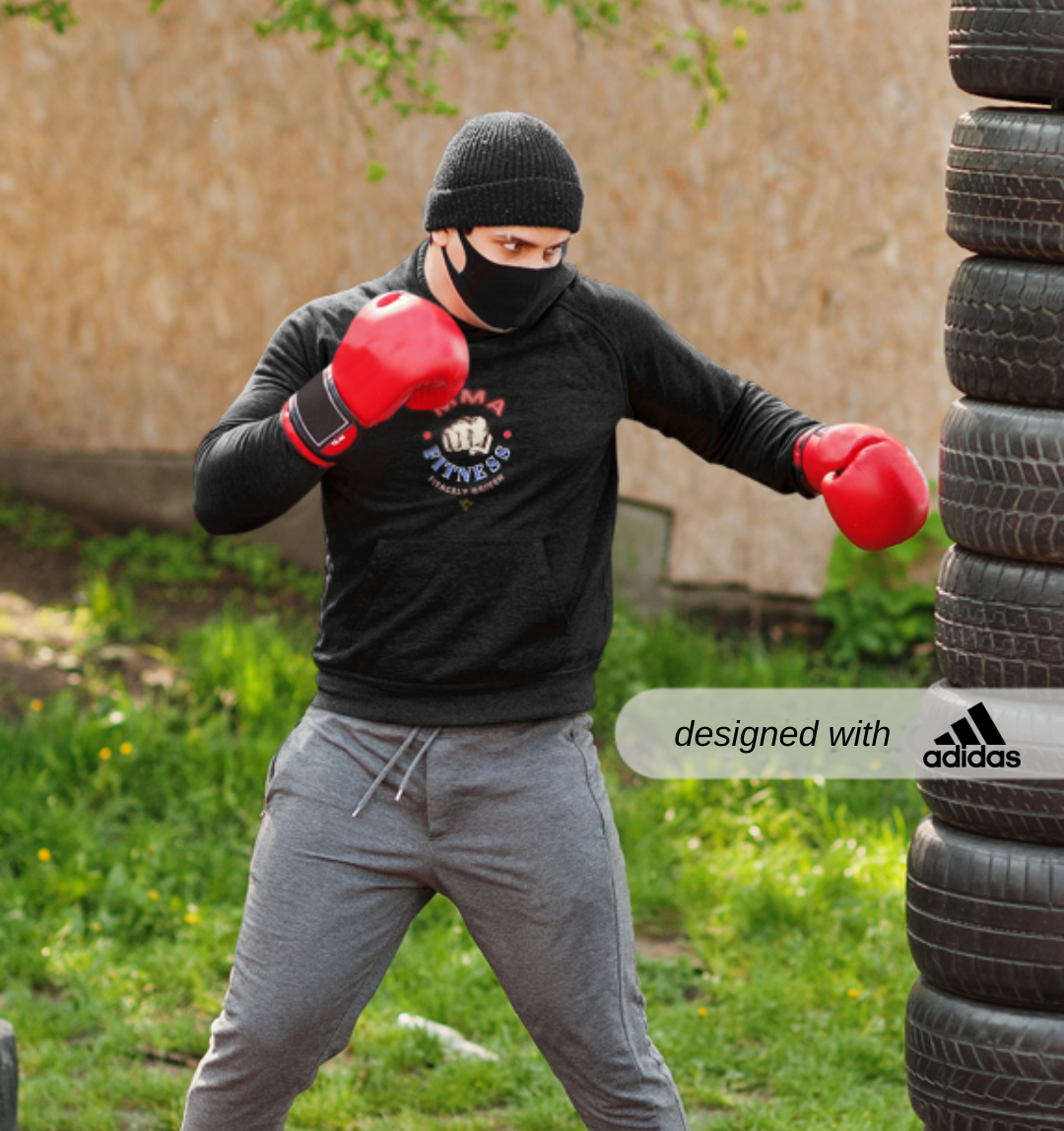 Adidas Sport Crewneck Sweatshirt for MMA Enthusiasts, Adidas MMA Sweatshirt, Person wearing red boxing gloves and a black Adidas sweatshirt, training with tires outdoors.