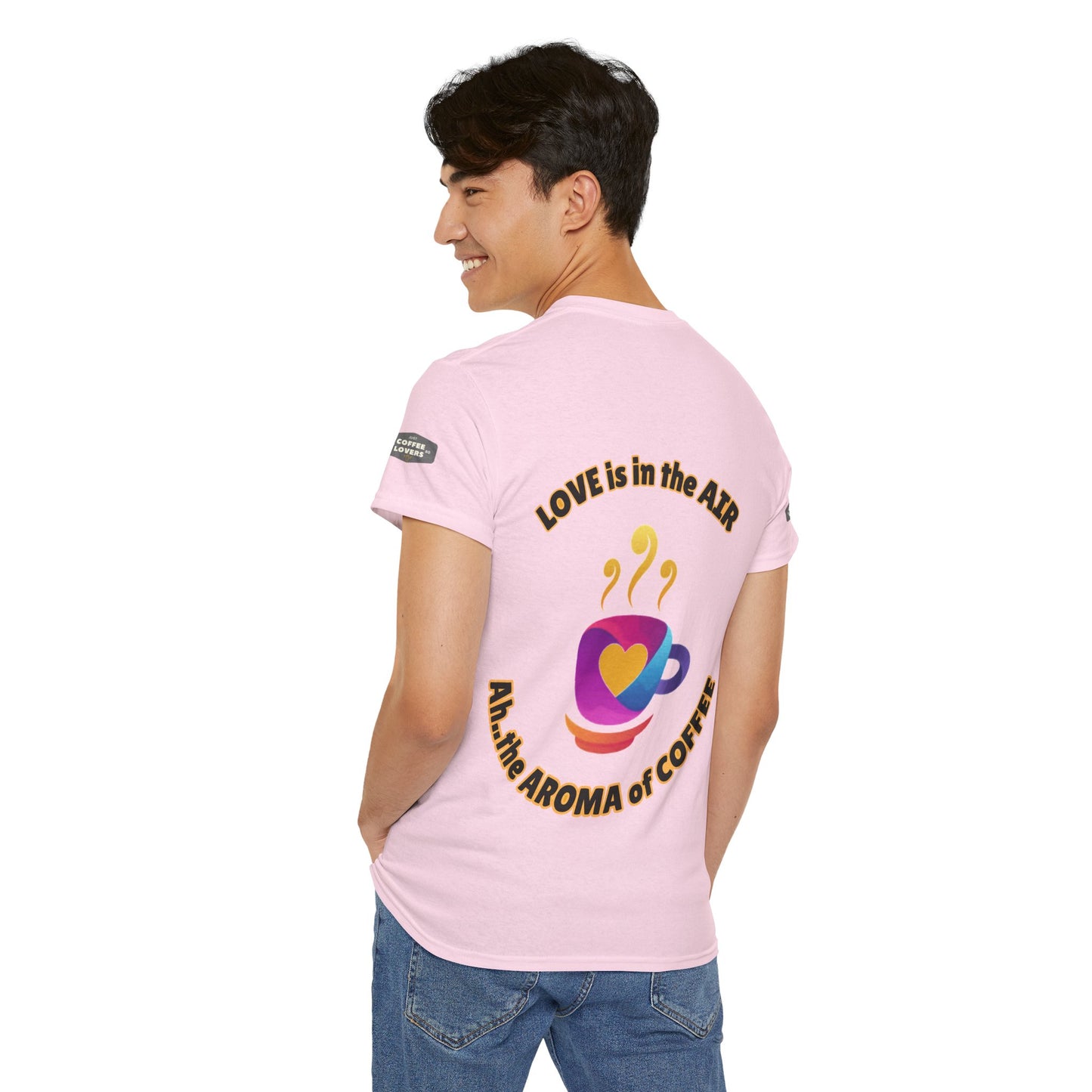 Coffee Lovers Tee with Quote - 'Love is in the Air Ah.. the Aroma of Coffee',  Person wearing a pink t-shirt with text and graphics on the back, standing against a white background