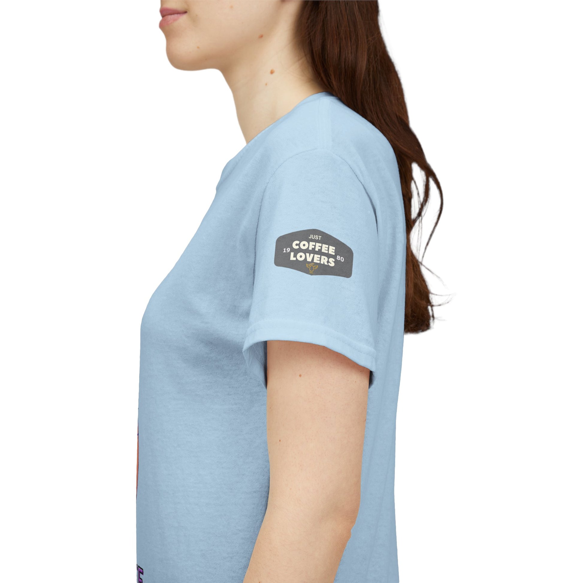 Coffee Lovers' t-shirt, Light blue t-shirt with a patch on the sleeve, worn by a person.