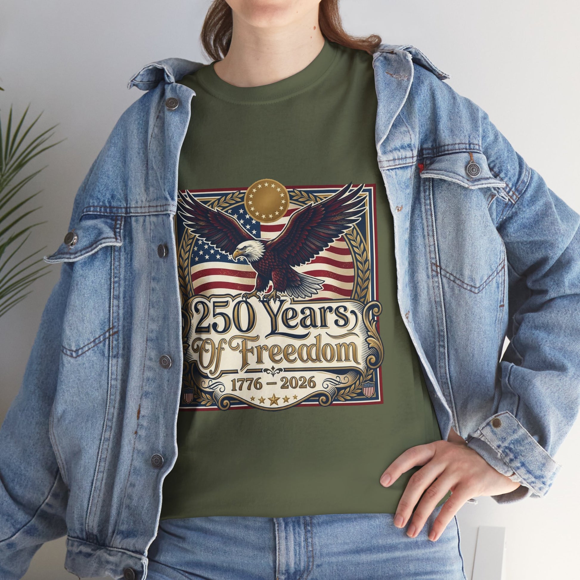 250 Years of Freedom T-Shirt — USA 250TH Anniversary Patriotic Eagle Tee, Person wearing a green t-shirt with an eagle and American flag design, standing indoors.