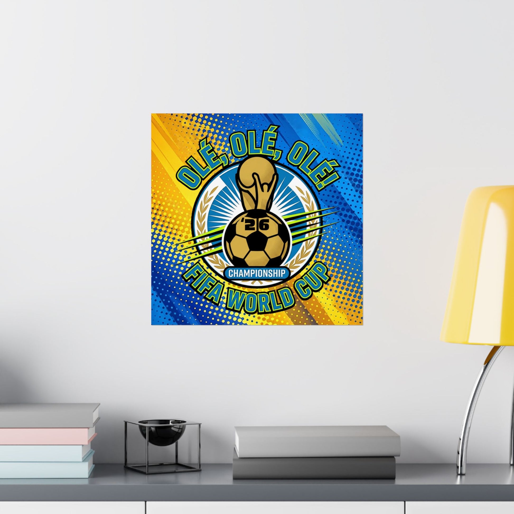 FIFA World Cup-themed decorative wall art on a white wall with books and a lamp in the foreground.