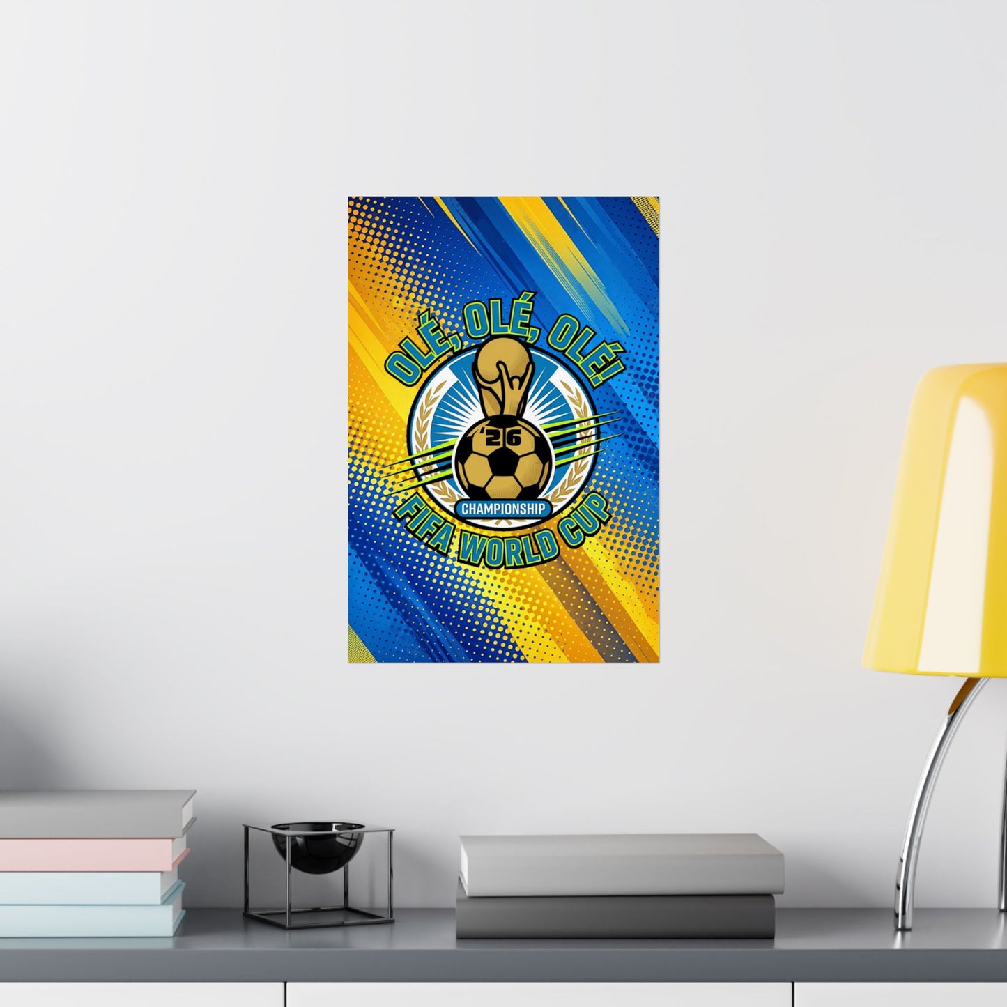 Framed poster with a soccer design on a wall above a desk with books and a lamp.