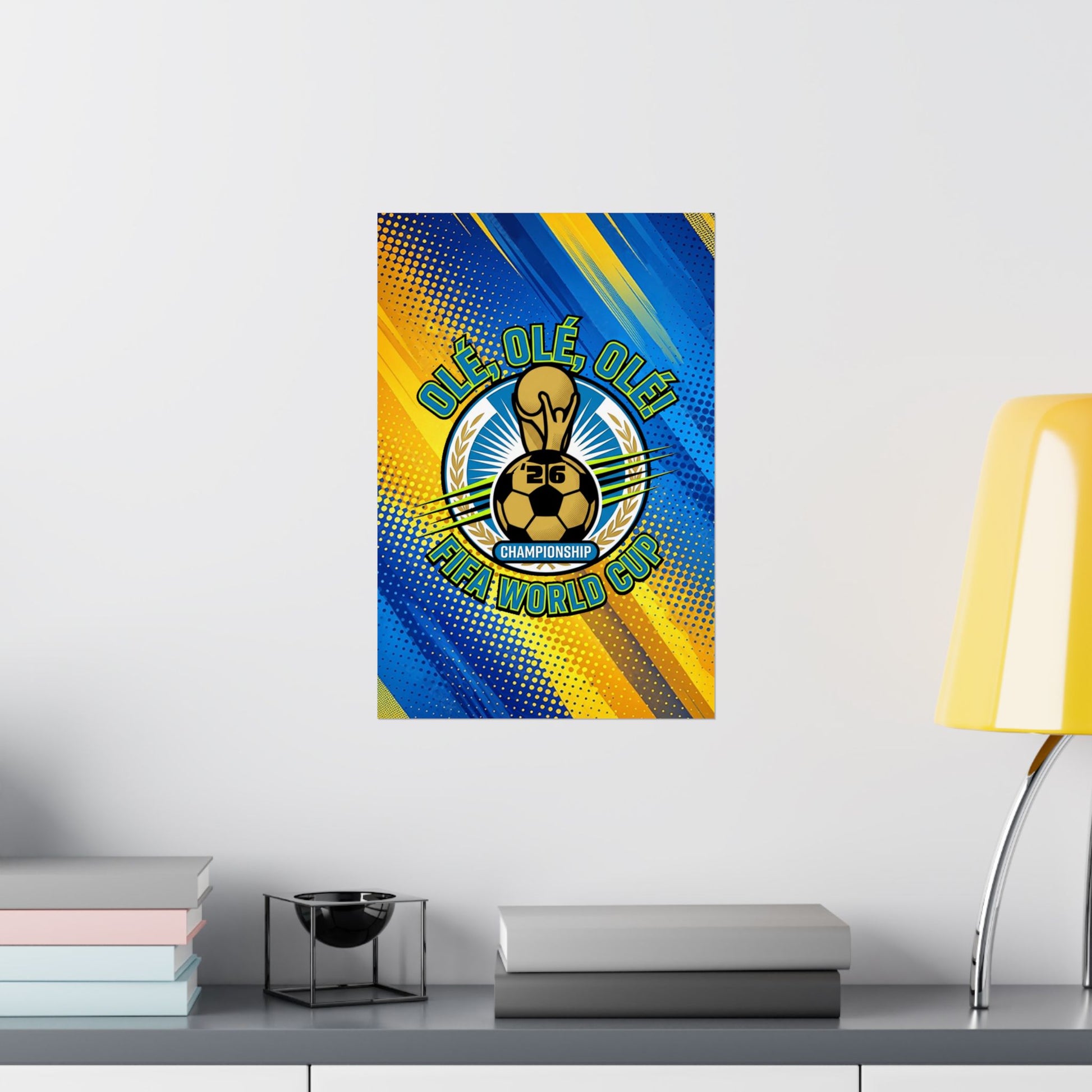 Framed poster with a soccer design on a wall above a desk with books and a lamp.
