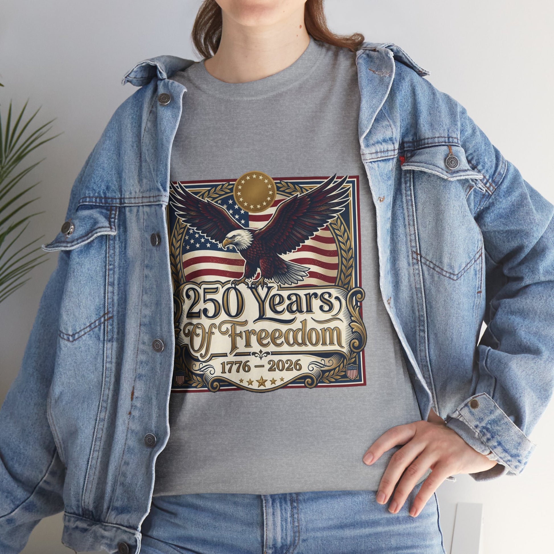 250 Years of Freedom T-Shirt — USA 250TH Anniversary Patriotic Eagle Tee, Person wearing a gray t-shirt with an eagle and American flag design, standing indoors.
