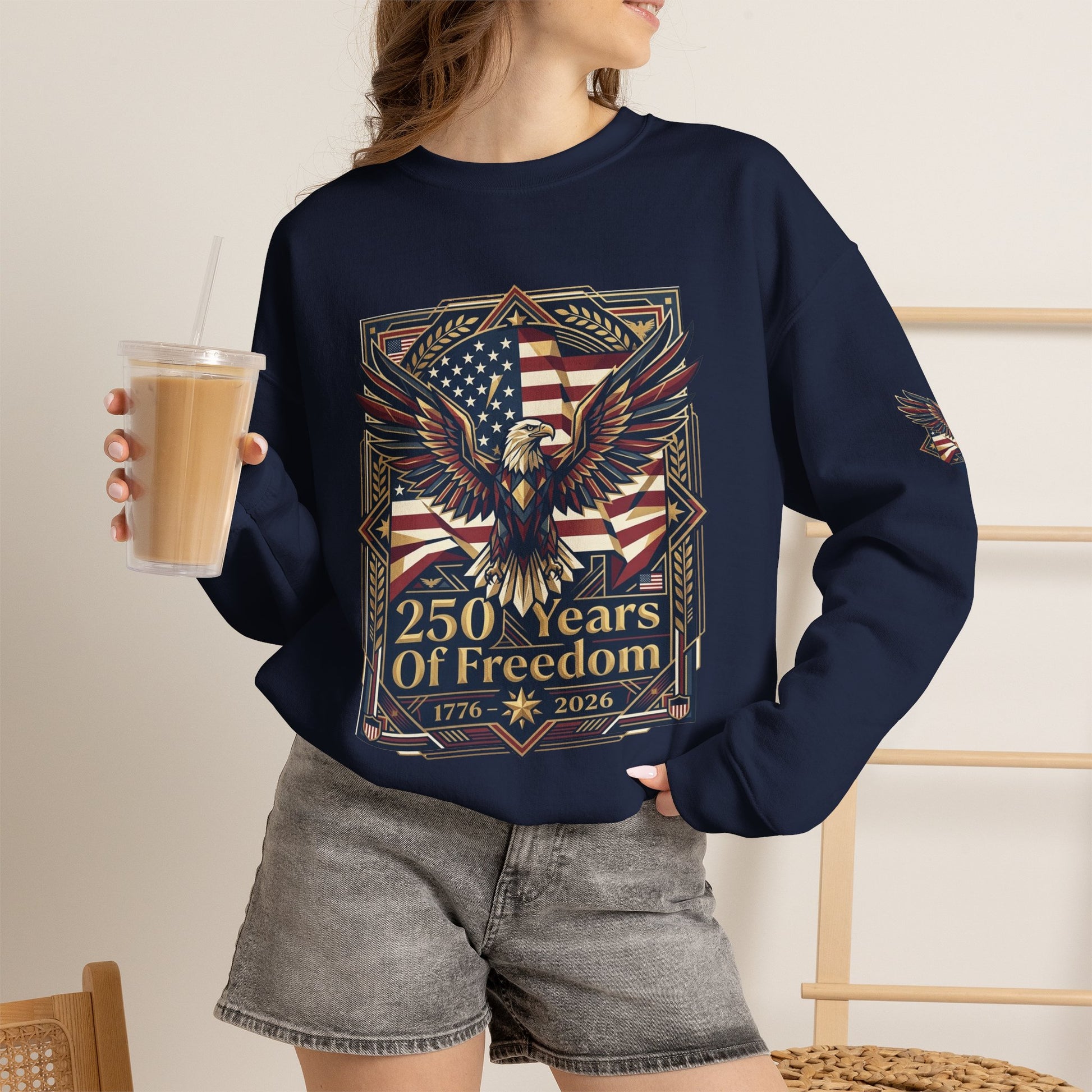 USA 250th ANNIVERSARY Crewneck Sweatshirt , Person wearing a navy blue sweatshirt with a crown of thorns design, holding a drink.