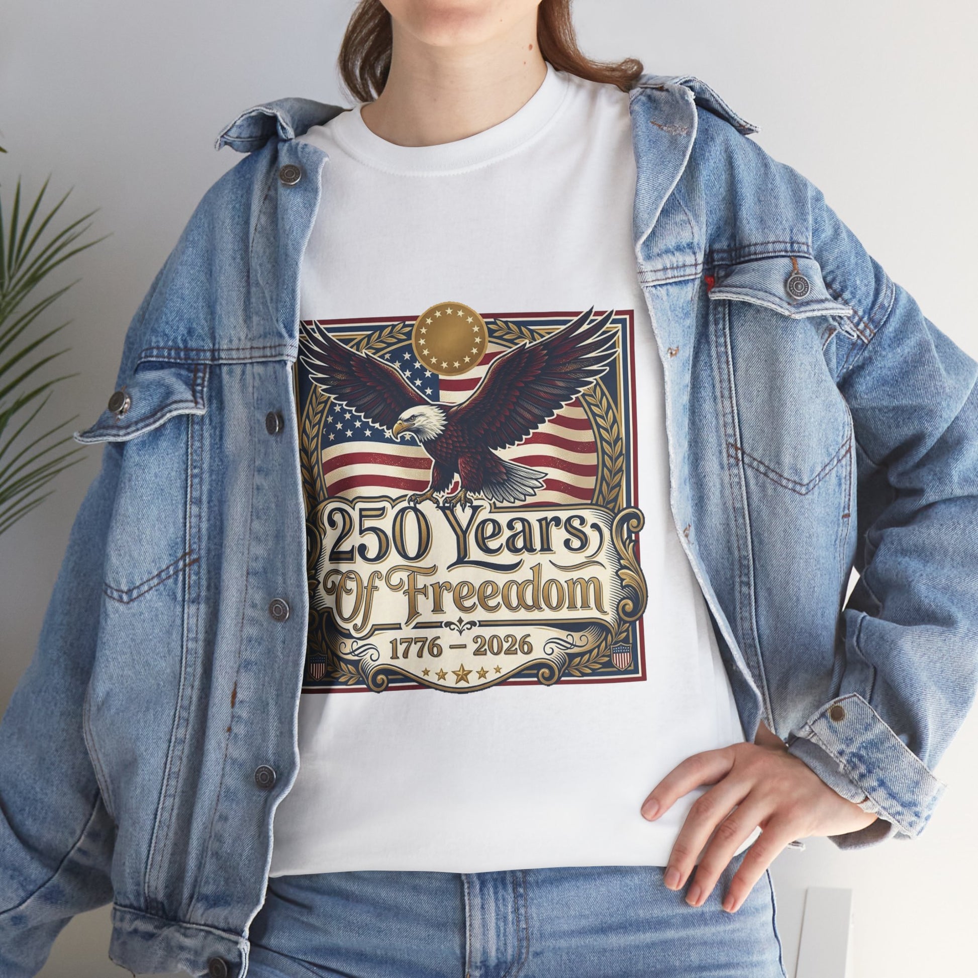 250 Years of Freedom T-Shirt — USA 250TH Anniversary Patriotic Eagle Tee, Person wearing a white t-shirt with an eagle and American flag design, standing indoors.