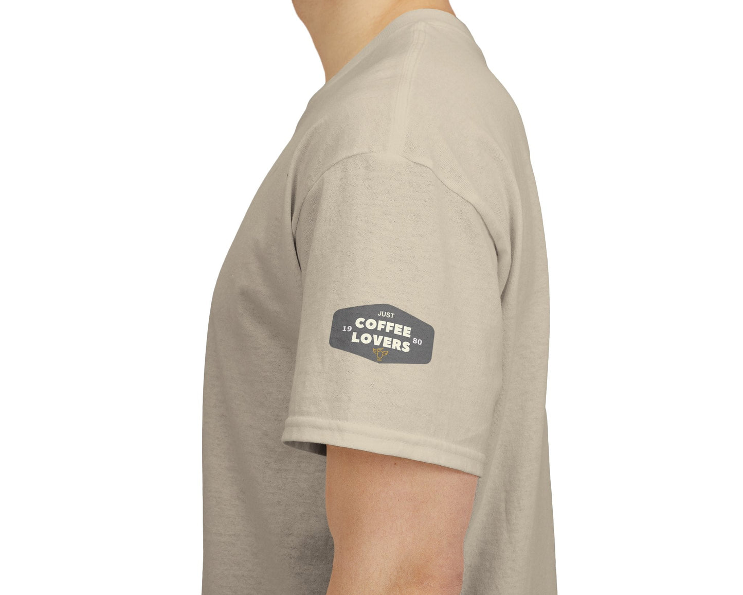 Coffee Lovers Cotton Tee - 'Better Late than Never', Beige t-shirt with a logo on the sleeve worn by a person, white background