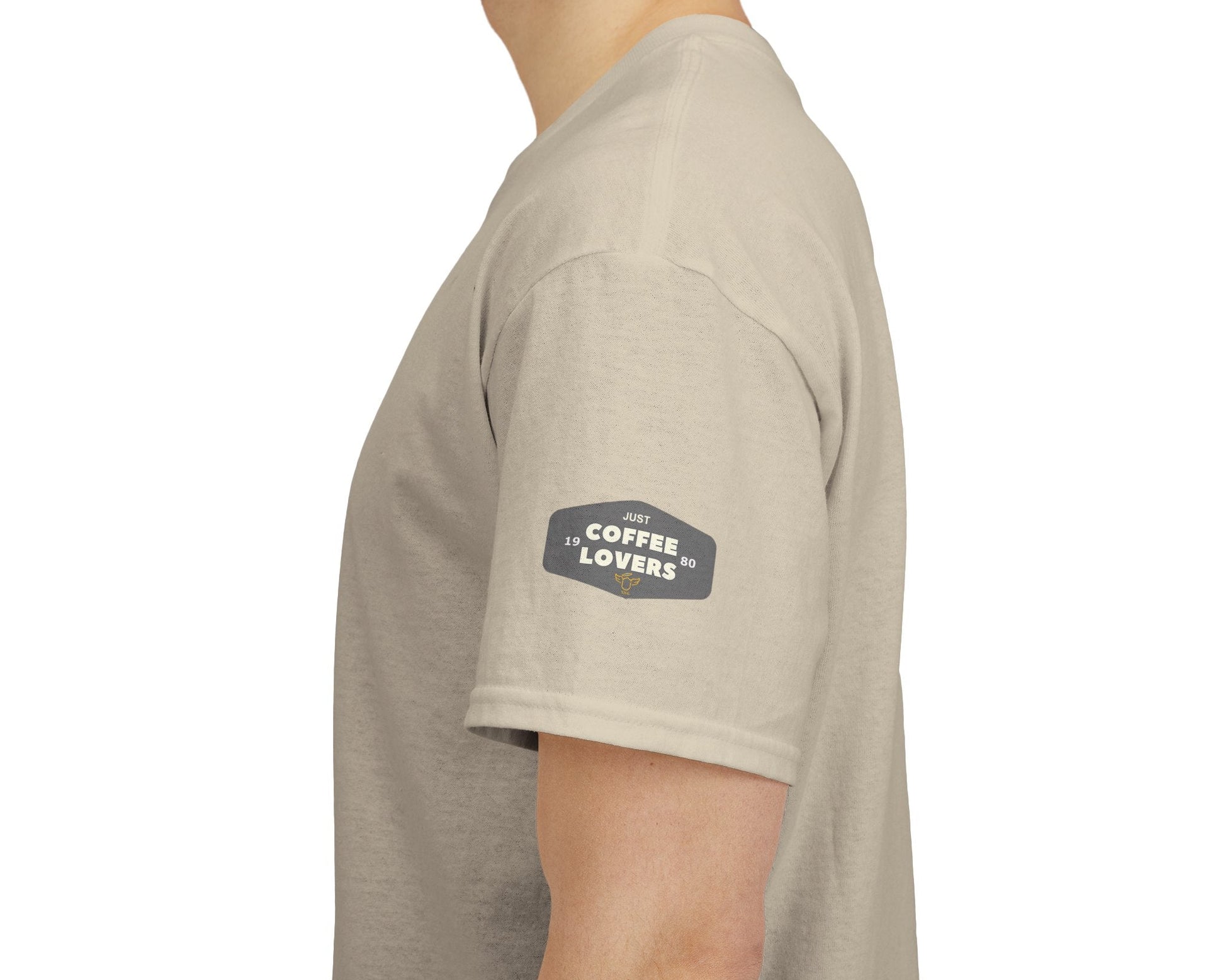 Coffee Lovers Cotton Tee - 'Better Late than Never', Beige t-shirt with a logo on the sleeve worn by a person, white background