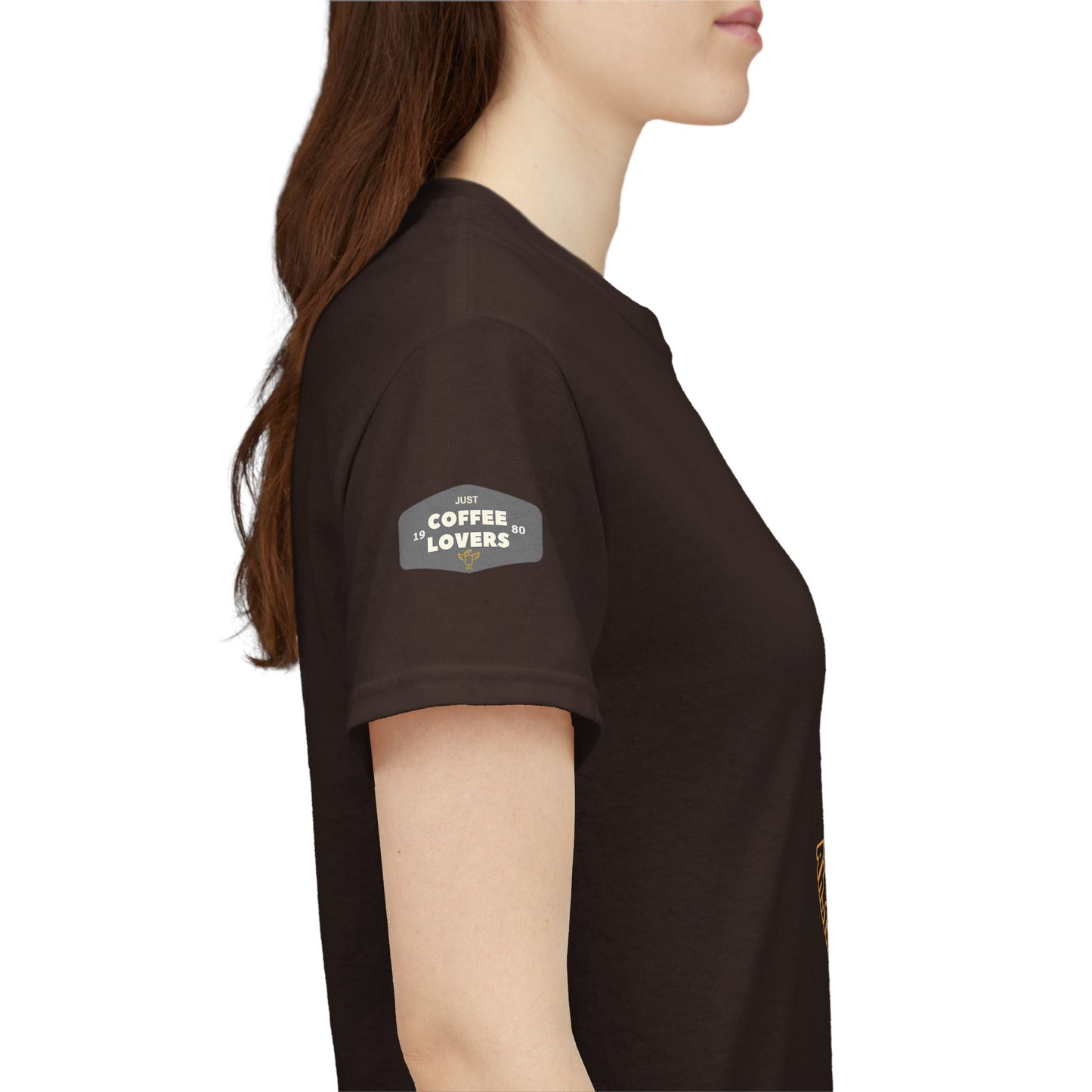 Coffee Lovers Tee with Quote - 'Love is in the Air Ah.. the Aroma of Coffee',  Person wearing a brown t-shirt with a logo on the sleeve against a white background