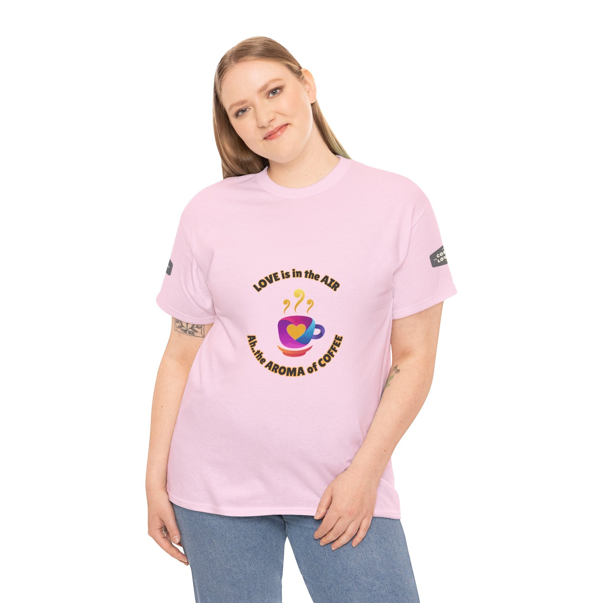 Coffee Lovers Tee with Quote - 'Love is in the Air Ah.. the Aroma of Coffee',  Person wearing a pink t-shirt with a graphic design on a white background