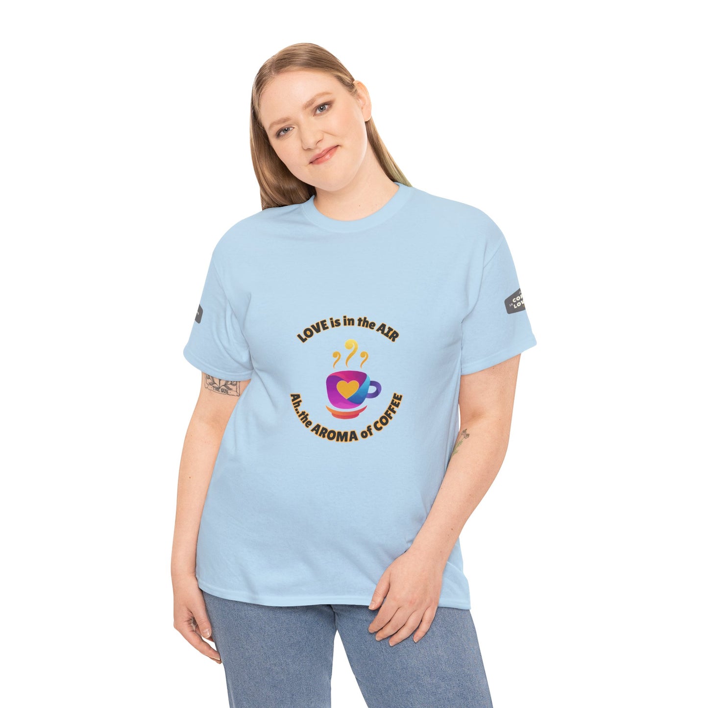 Coffee Lovers Tee with Quote - 'Love is in the Air Ah.. the Aroma of Coffee',  Woman wearing a light blue t-shirt with a colorful graphic and text on a white background