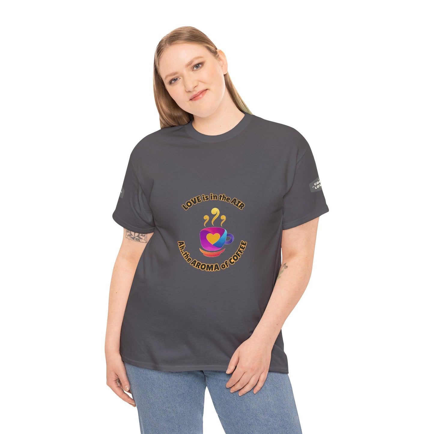 Coffee Lovers Tee with Quote - 'Love is in the Air Ah.. the Aroma of Coffee',  Person wearing a dark gray t-shirt with a colorful graphic design on a white background