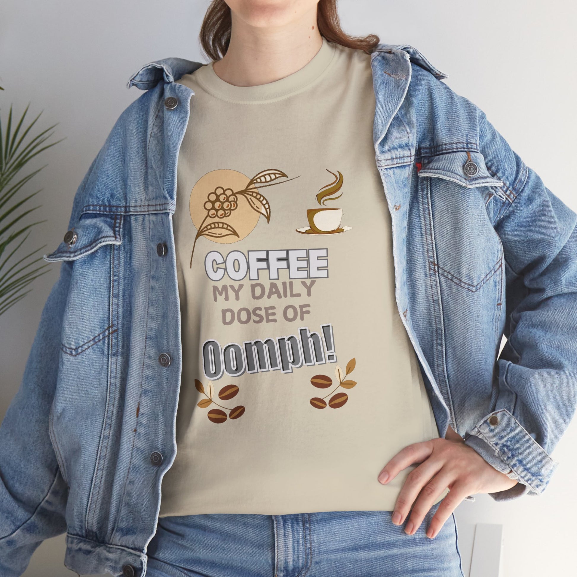 Coffee Lovers Heavy Cotton Tee - My Daily Dose of Oomph! Person wearing a beige t-shirt with coffee-themed design and denim jacket.