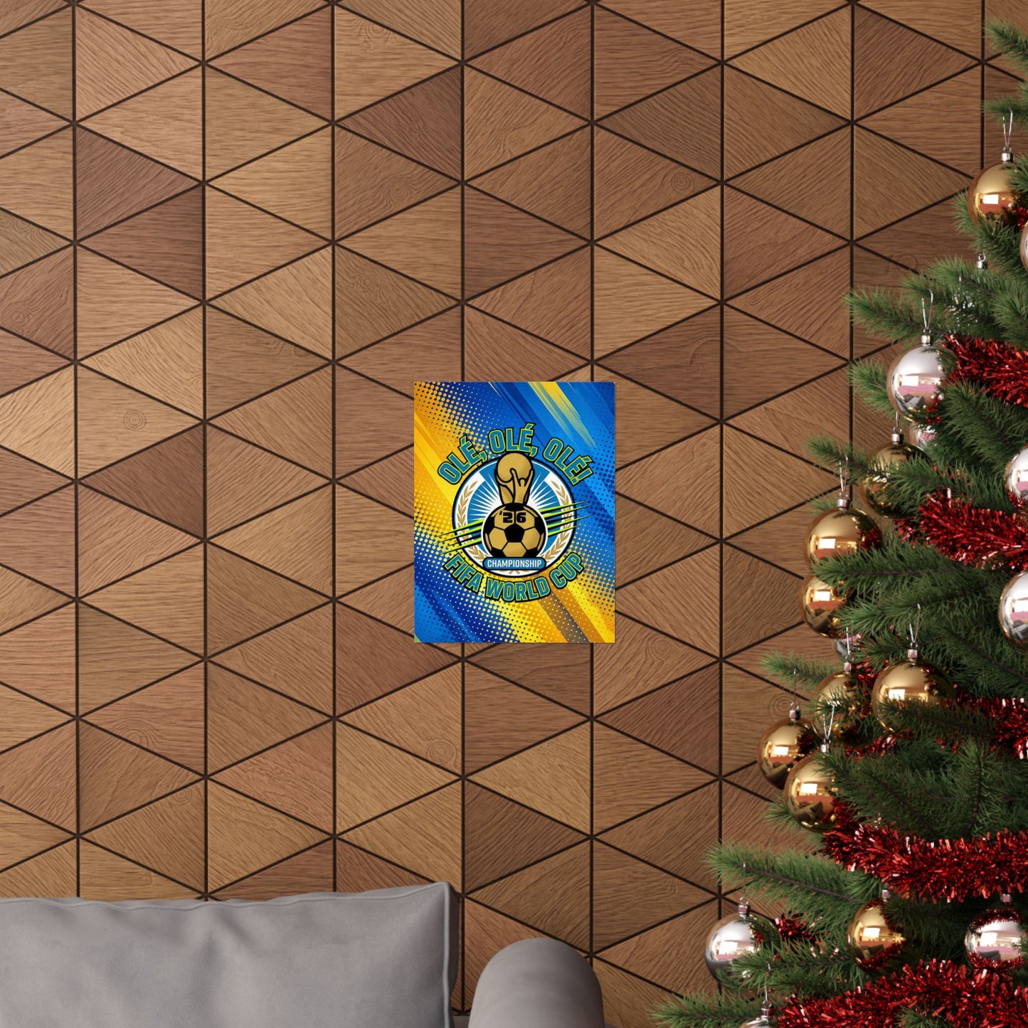 Decorative wall art with a logo on a geometric-patterned wall next to a Christmas tree.