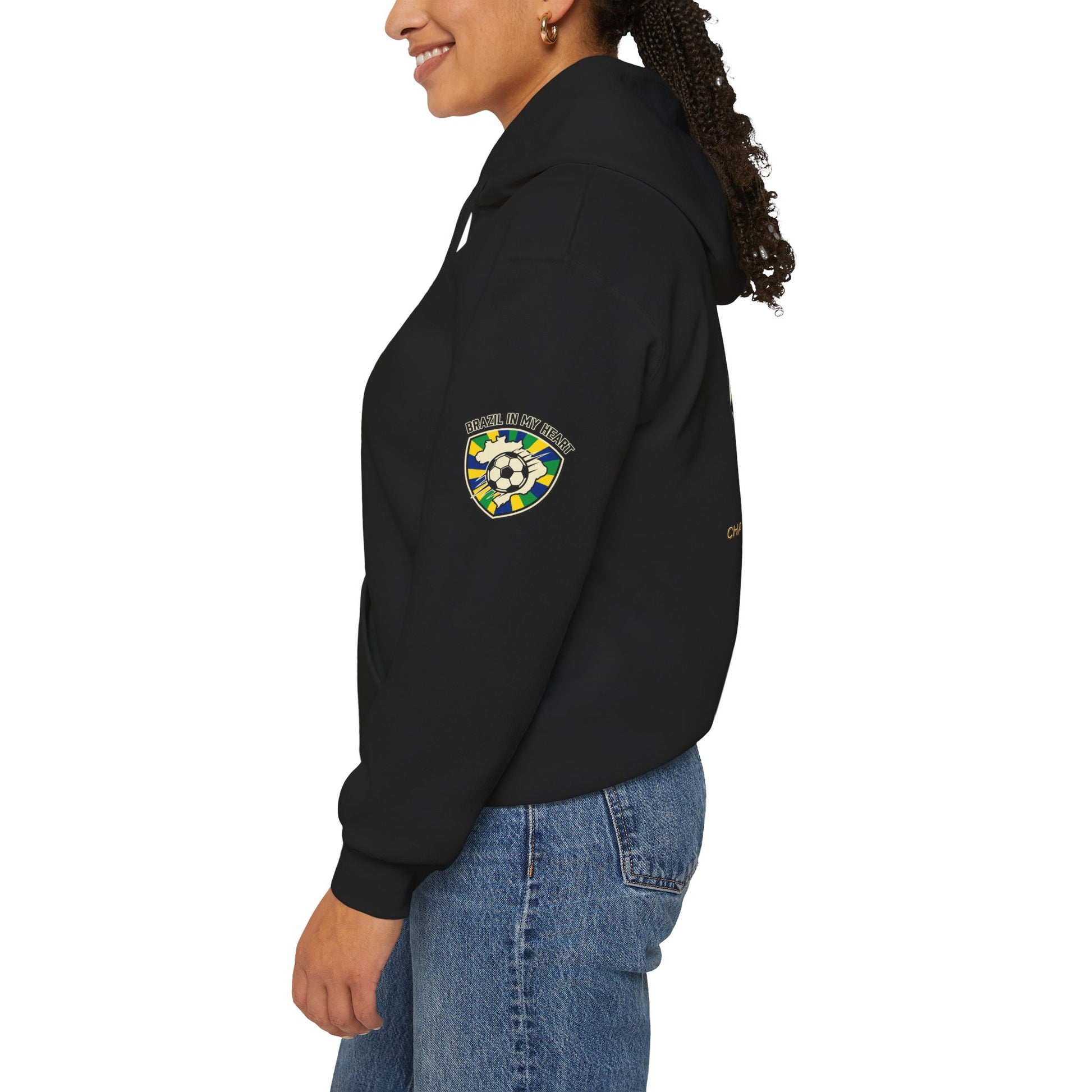 Person wearing a black hoodie with a logo on the sleeve against a white background