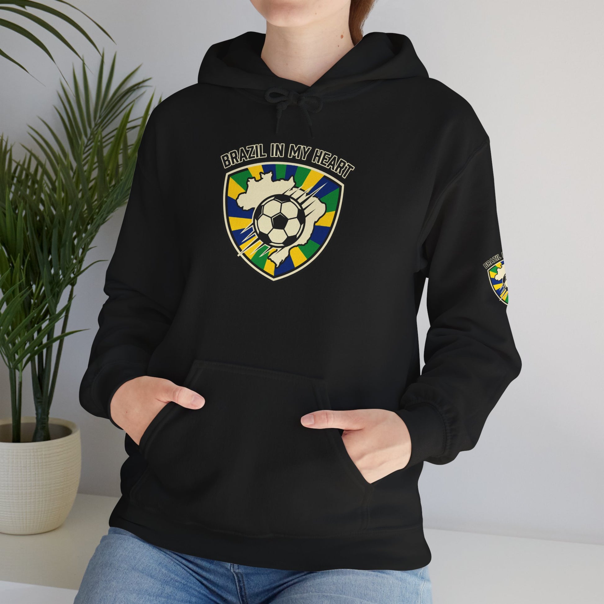 Person wearing a black hoodie with a colorful graphic of a cat on a white background
