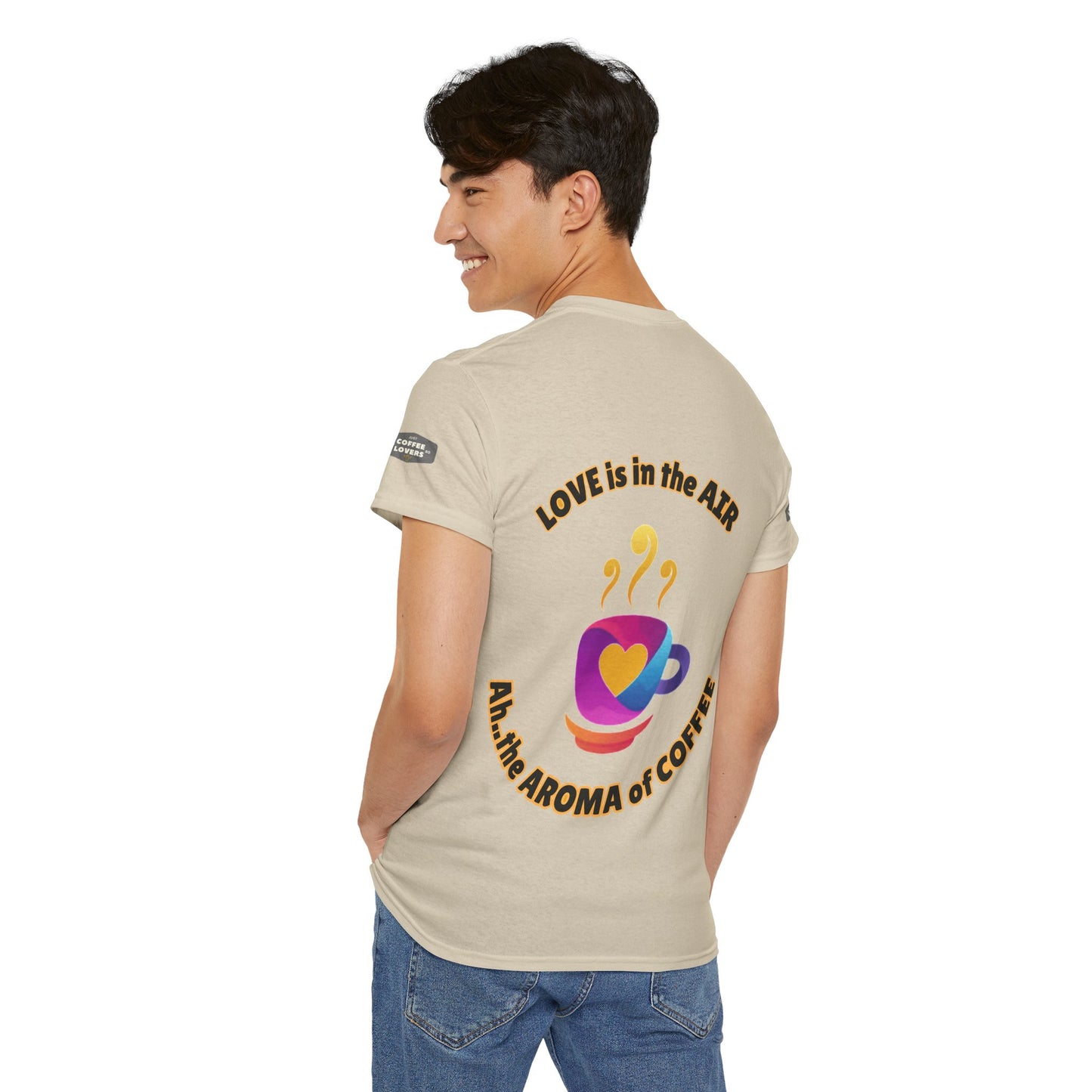 Coffee Lovers Tee with Quote - 'Love is in the Air Ah.. the Aroma of Coffee',  Person wearing a beige t-shirt with text and graphics on a white background